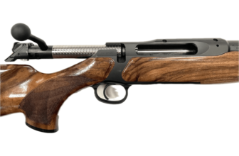 Close-up of a sleek, modern rifle showcasing detailed wood grain and precision engineering. Ideal for hunting enthusiasts.
